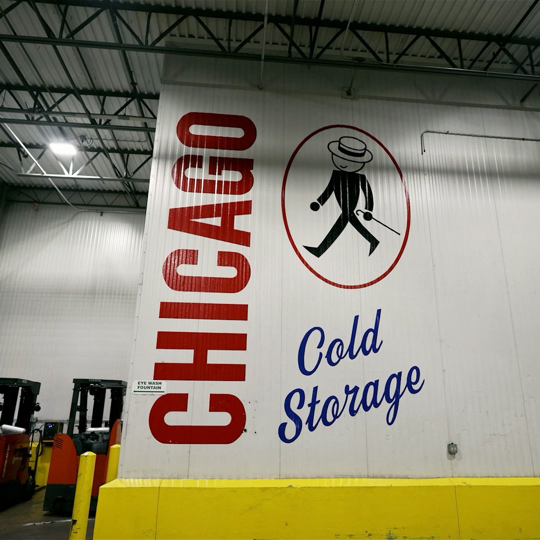 Interior wall sign for 'Chicago Cold Storage' featuring the logo of a stick figure in a hat.