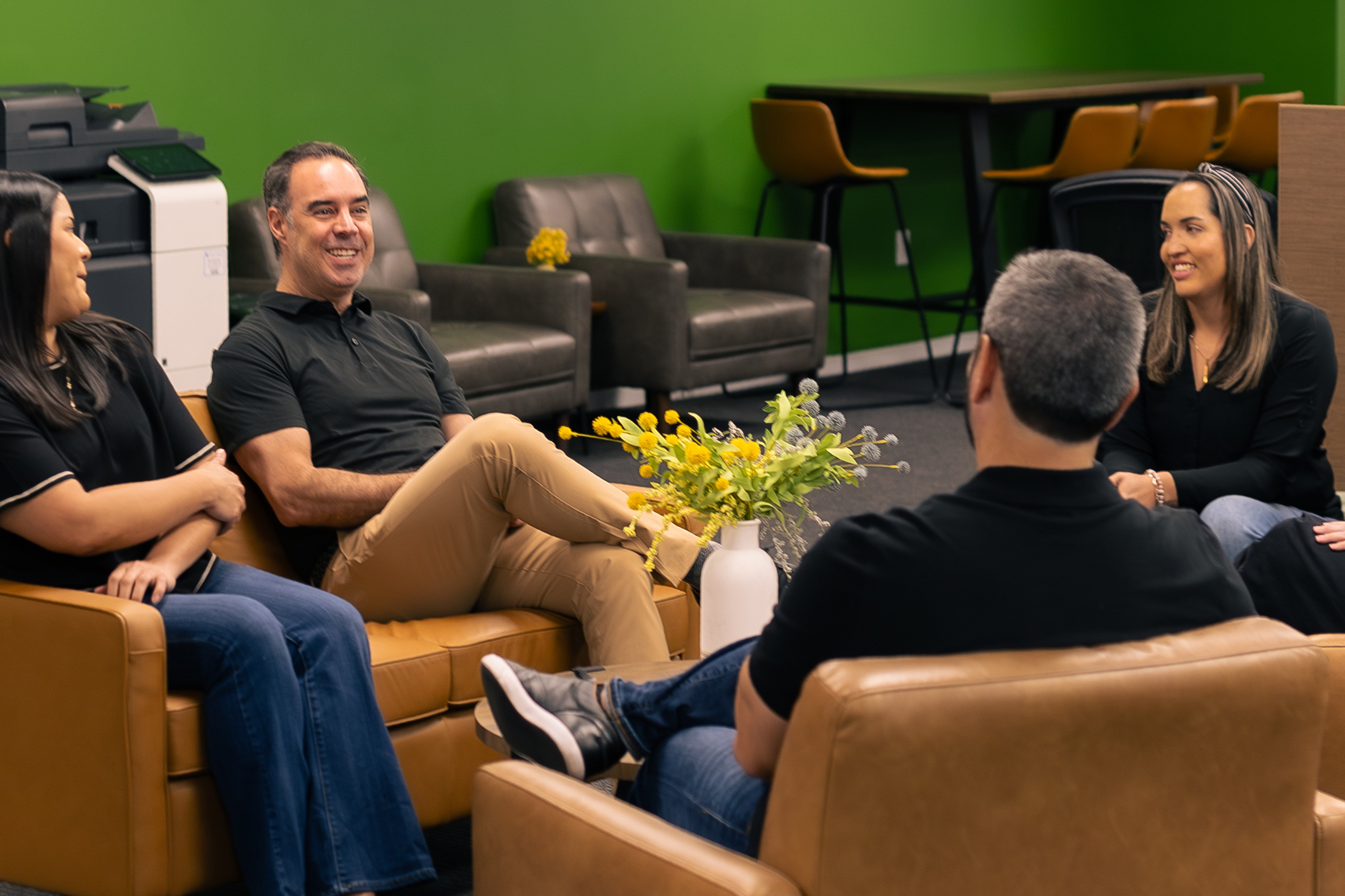 Image of a Source Logistics team sitting in a comfortable room